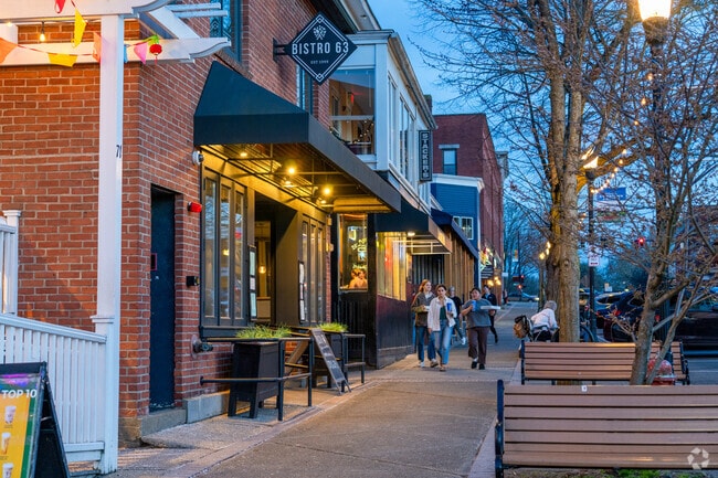 Folks walk through along Amherst's historic Main Street lined with shops and restaurants.