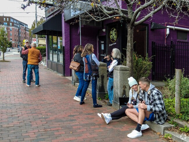 Locals wait outside of the popular Hot Suppa restaurant in the Parkside neighborhood.