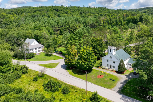 A group of larger homes in the Town of Sutton, NH with expansive yards and surround forest areas