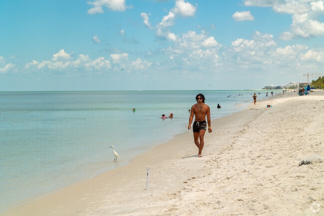 Naples beach is a great place for a sunny stroll closeby to Royal Harbor.