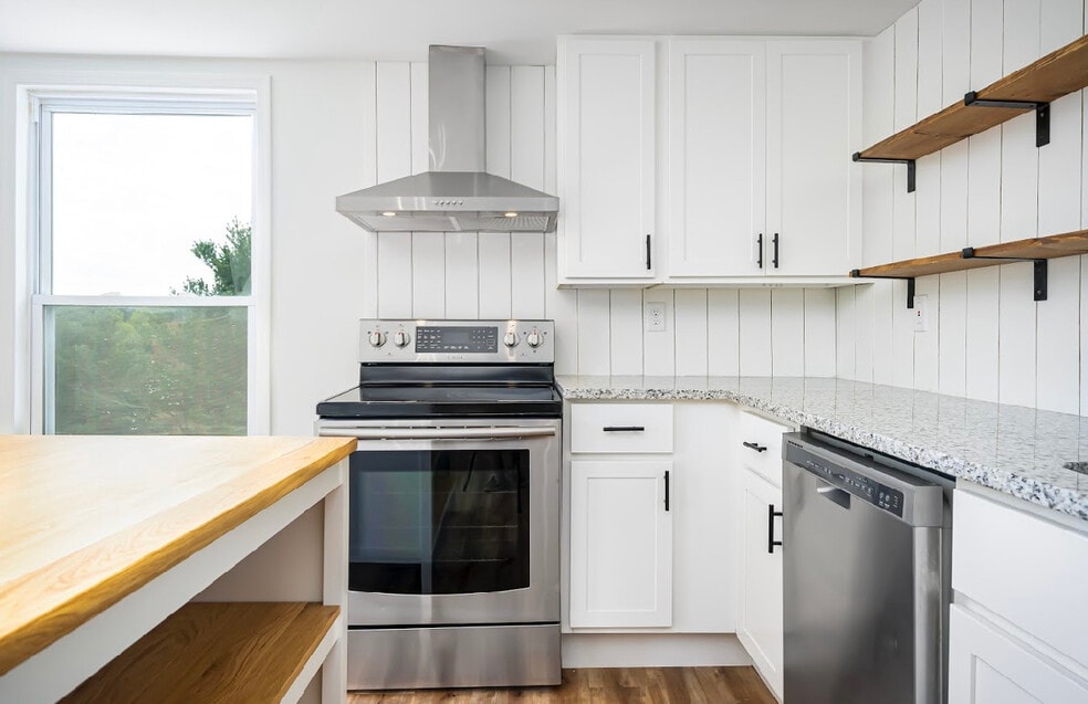 Kitchen w granite, stainless appliances and open shelving