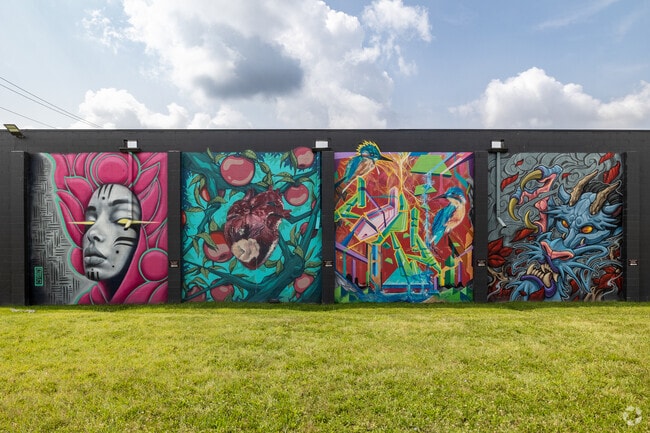 This fantastic mural is painted on the side of Red Tree Tattoo in Devon Circle.