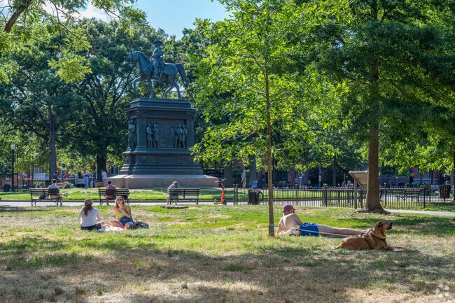 Residents and visitors alike come to relax o n the green surrounding Logan Circle.