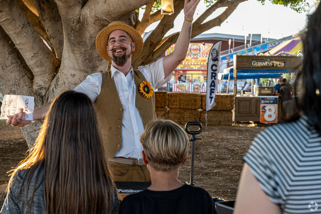 Locals enjoy a live magic show at Yuma's Fall Fest at the Yuma County Fairgrounds.