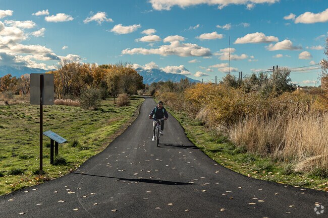 A man in Chesterfield rides his bike down Jordan River Trail on a fall day.