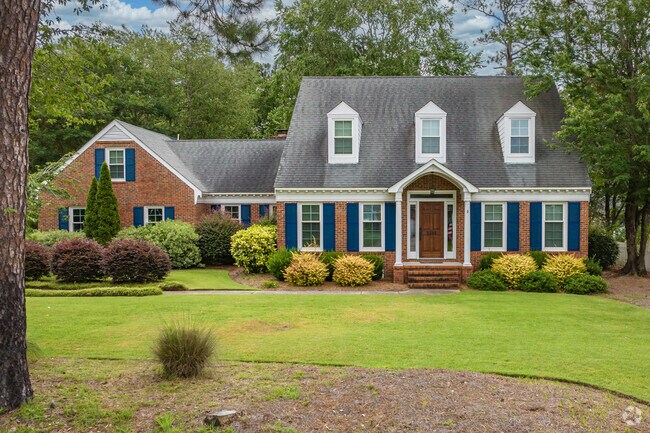 A Cape Cod home nestles under mature trees in Woodberry Forest.