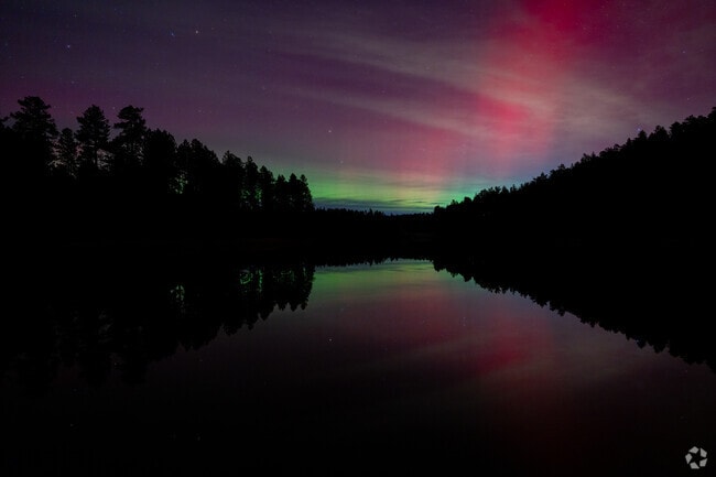 Just half an hour from Colonial Pine Hills, Horse Thief Lake glows with vibrant northern lights.