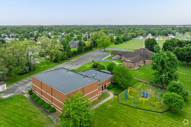 Lenawee Seventh-Day Adventist School features a large play area behind the school for recess.