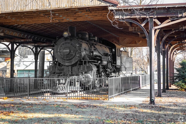 Visits the train memorial at Military Park in Newton.