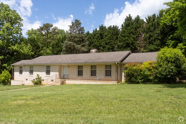 A white home mixed with brick and vinyl in Beatties Ford-Trinity.