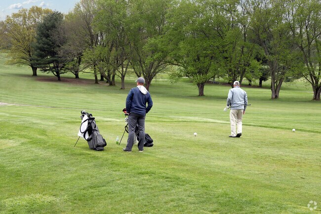 Golfers tee off at Winding River Golf Course, a busy public course in Southern Dunes, Indiana.