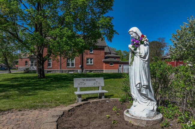 A sculpture of the Virgin Mary overlooks the garden of the Saint John Cantius Parish.