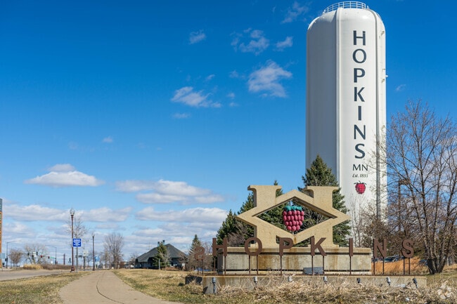 A sign and water tower welcomes people to the city of Hopkins.