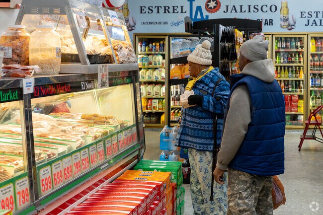 Some customers order from the butcher at El Novillo Market.