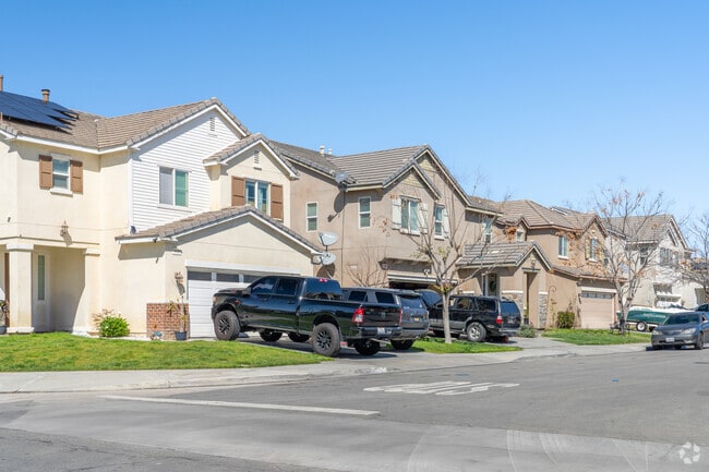 A row of modern contemporary homes features sleek lines, large windows, and stylish designs, offering a fresh, sophisticated look in a vibrant neighborhood.