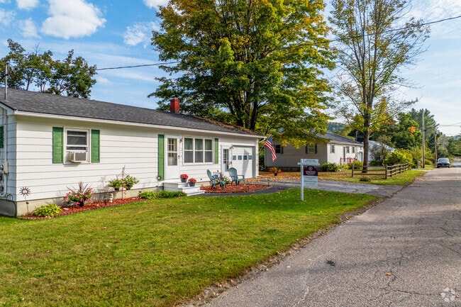 A row of ranch style homes in Northfield Street have quaint yards and glow in the sunlight.
