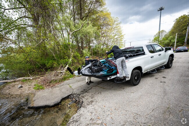 A group of friends is returning from kayaking at Gorton Pond in Greenwood, RI.