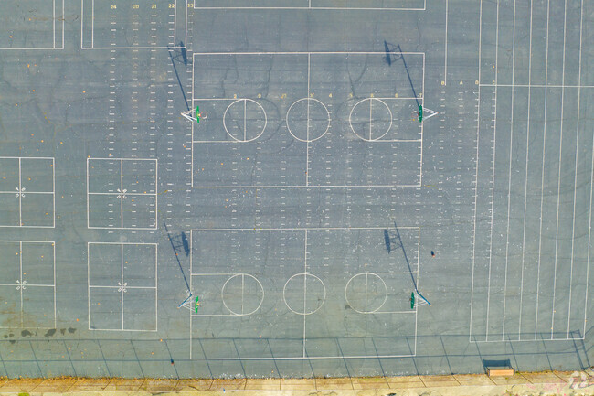 The play area at William G Paden Elementary School is all cement with basketball for kids.