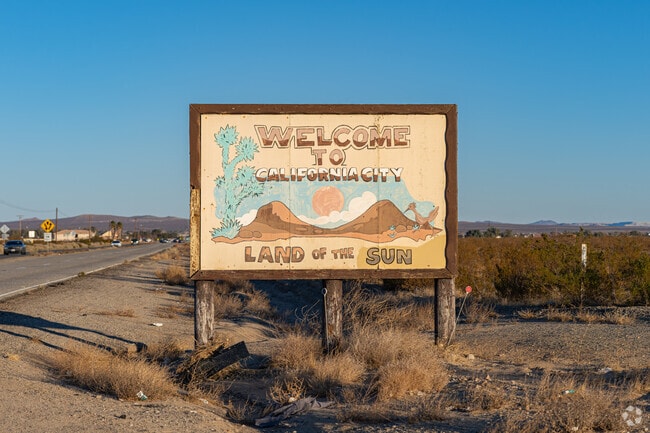 A rustic sign welcomes visitors to California City.