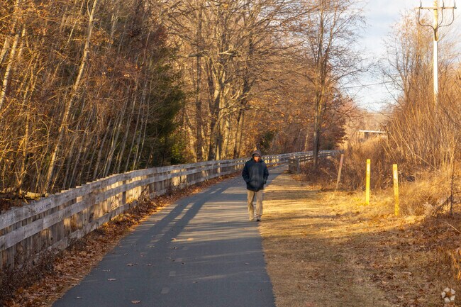 A person takes a stroll down the Redstone Rail Trail in East Longmeadow.