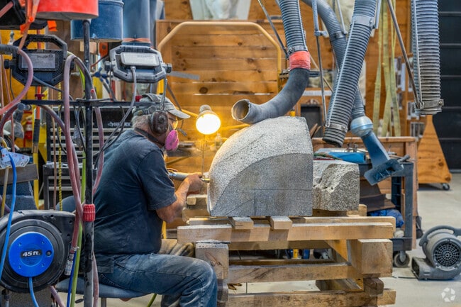 A resident sculptor at the Vermont Granite Museum, near Websterville, carves a piece of granite.