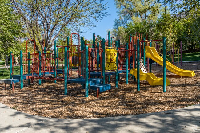Playground facilities at Spring Creek Park in Little Rock Canyon include slides, swings, and shaded seating areas.