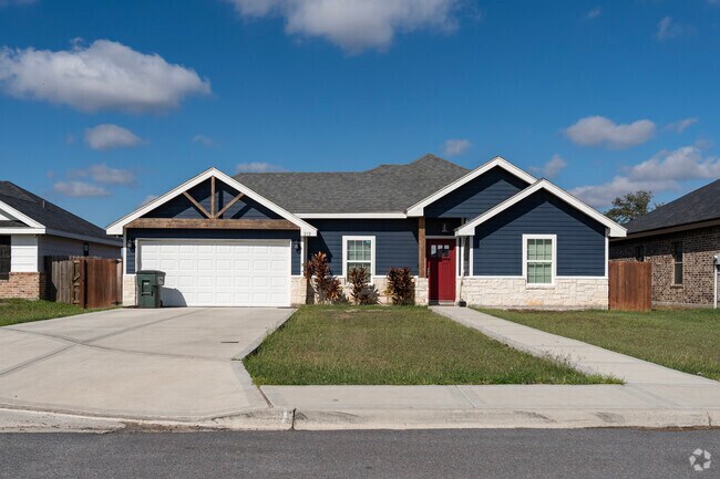 A blue brick and wood frame style home located in the south side of La Villa.