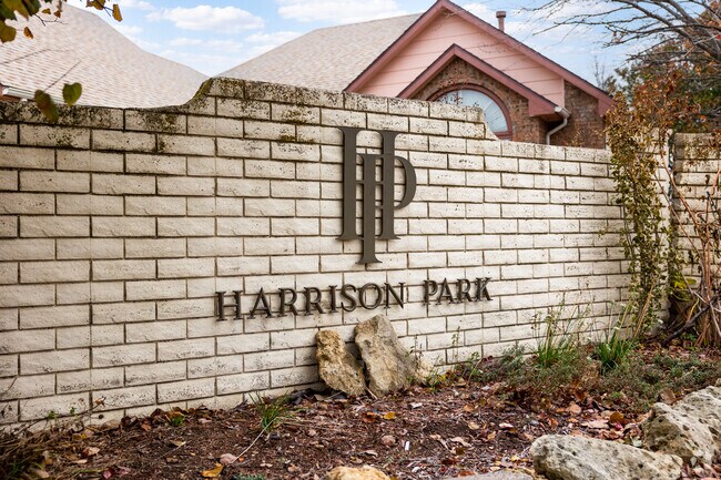 The entry to Harrison Park greets residents with a large white-brick sign.