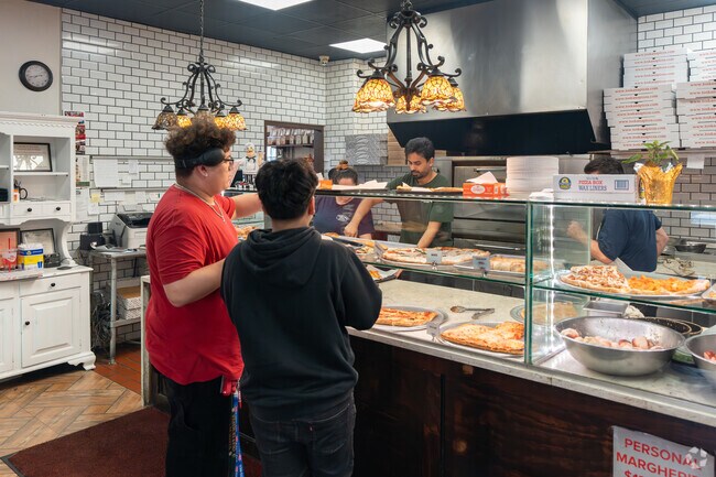 Enjoy a fresh, hot slice of pizza at Toskana in Westbury.