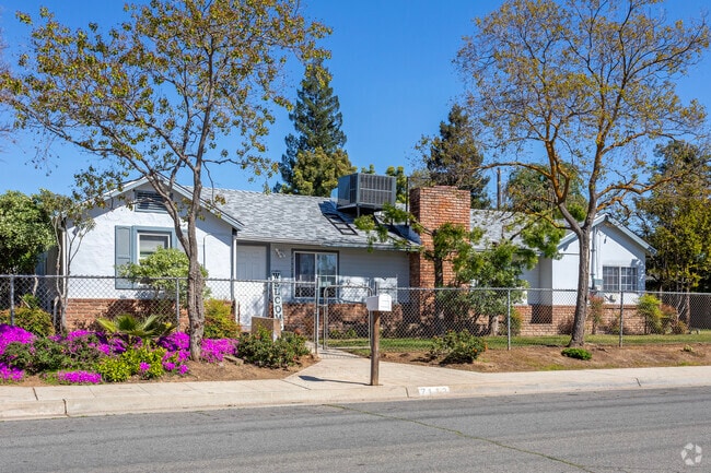 A Ranch style home with a colorful yard in Pinedale.