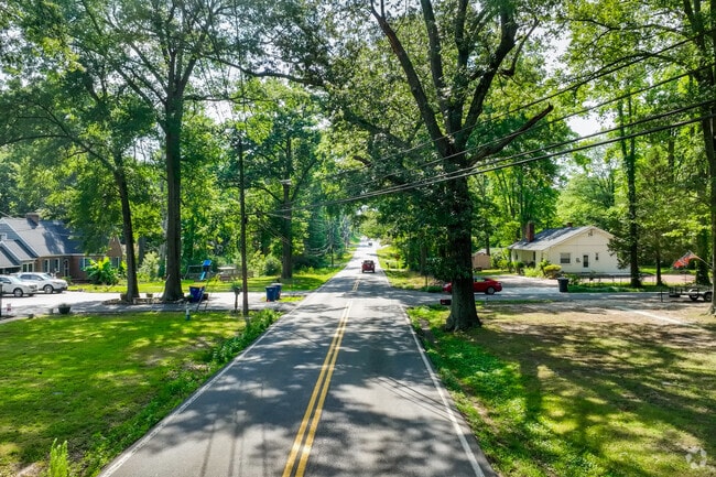 Mature shade trees tower over the streets in the neighborhood of Bensley.
