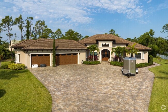 Custom-built homes with multi-car garages sit on large lots in Council, Bonita Springs.
