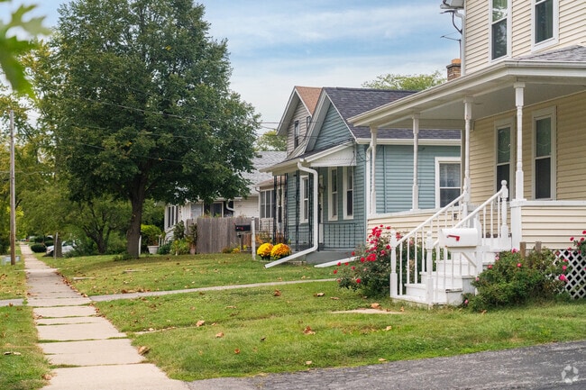 Bright flowers embellish the yards of Pigeon Hill homes in Aurora, Illinois.