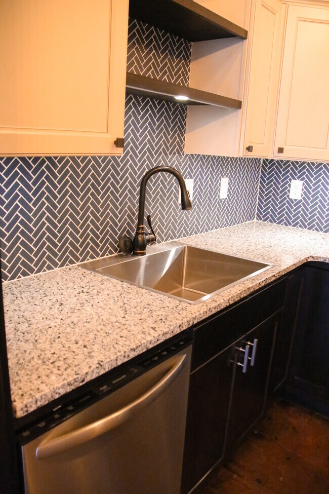 Granite kitchen counter top with herringbone backslash.
