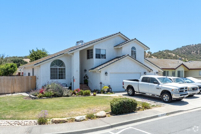 This Mediterranean-style home in Pine Canyon features arched windows and tiled roofing.