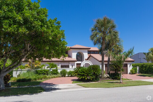 This sleek, Mediterranean home is a standout example of Jupiter Dunes' beauty.
