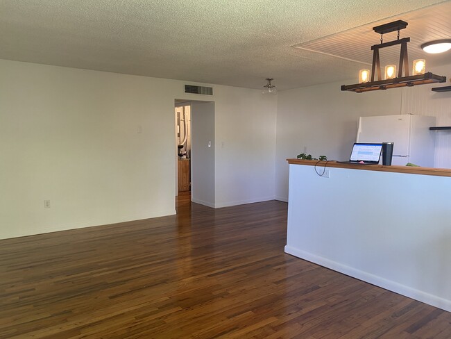 From front door looking at LR, dining and kitchen. Add granite bar top between Kitchen and LR.