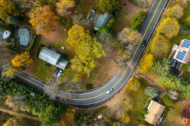 Tree-lined county roads wind by charming homes in Hempstead, NY.