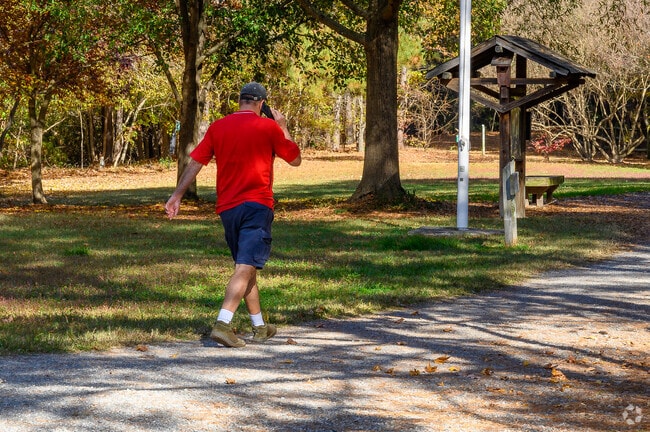 A walker explores scenic trails at Sandy Bottom Nature Park in Hampton.