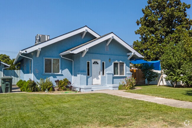 A colorful Craftsman home with a grassy lawn in Downtown Salida.