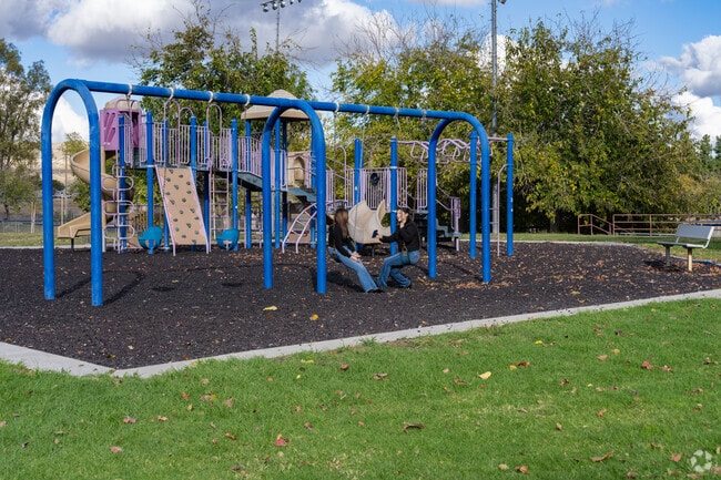 Shady trees and playgrounds make Ford City Park a central spot for families.