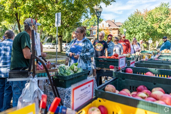 A line of customers wait to buy produce at the Cedar Falls Farmers Market.