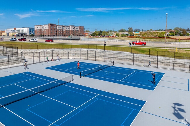 Students at Nicolet High School in Glendale, beginning tennis practice.