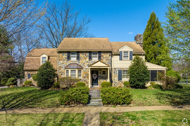 This stone colonial in Alapocas has plenty of greenery.