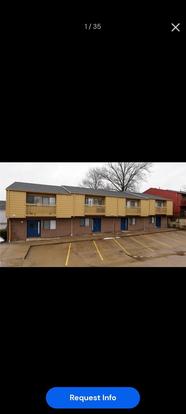 Front view of Building with multiple parking spots