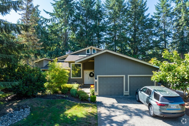 This mid-century split-level home blends in with the natural beauty of Mill Creek.