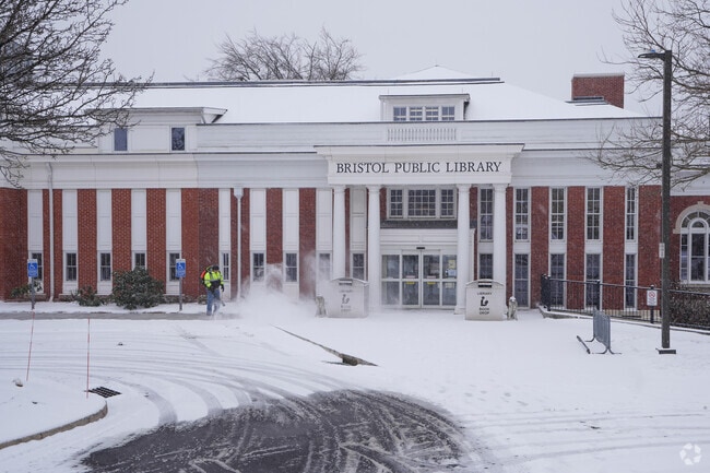Bristol Public Library sidewalk being plowed.