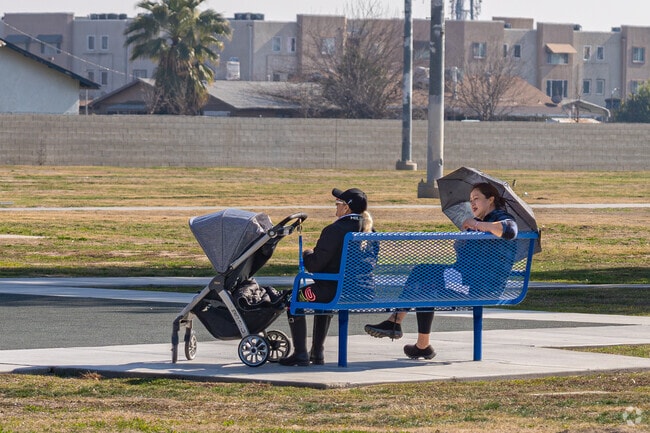 A couple of grandmothers look as the kids play at Casa Loma County Park.