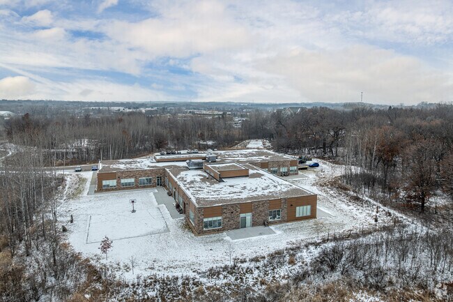 There is a sport court outside Aris Woodwinds.