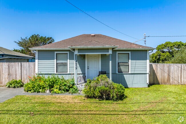 This bungalow has the typical small front porch with a detached garage.